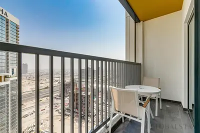 a balcony with a table and a view of the city at GlobalStay The Crest Tower C Apartments Dubai in Dubai