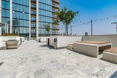 a patio with benches and a building at GlobalStay The Crest Tower C Apartments Dubai in Dubai