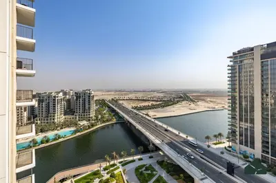 a bridge over a river in a city with buildings at Luxurious 2BR with Sea and Burj View by BMS in Dubai