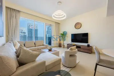 a living room with a couch and a tv at Aspin 1BHK Waterfront View - Creek Horizon in Dubai