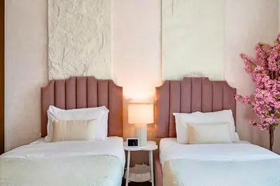 two beds sitting next to each other in a room at Cosmic Address 2BR Burj Views above Dubai Mall - By Maxx Value Homes in Dubai