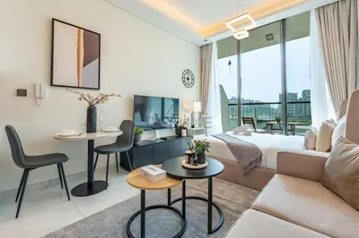 a hotel room with a bed and a couch at Walking distance to Dubai Miracle Garden and Butterfly Garden, Few minutes drive to Mall of the Emirates and IMG Worlds of Adventure - Samana Park Views, Arjan by Deluxe Holiday Homes in Dubai