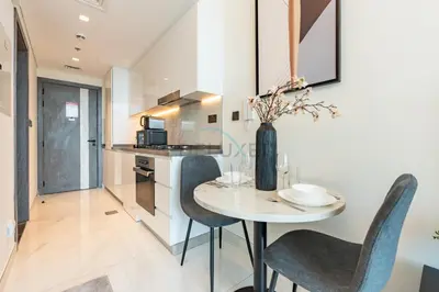 a kitchen and dining room with a table and chairs at Walking distance to Dubai Miracle Garden and Butterfly Garden, Few minutes drive to Mall of the Emirates and IMG Worlds of Adventure - Samana Park Views, Arjan by Deluxe Holiday Homes in Dubai