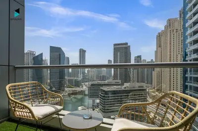 a balcony with chairs and a view of the city at Stylish Stay at Bay Central with Skyline Views in Dubai