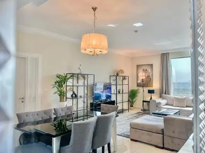 a living room with a table and chairs and a couch at 2 Bedroom Apt in Damac Capital Bay Tower A, Business Bay by Luxaura in Dubai