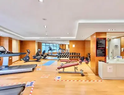 a gym with a lot of treadmills and exercise equipment at 2 Bedroom Apt in Damac Capital Bay Tower A, Business Bay by Luxaura in Dubai