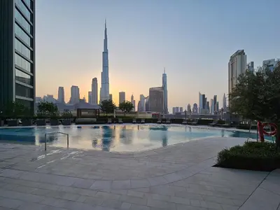 a large pool with a city skyline in the background at Luxury-Brand New-Direct Access toThe Dubai Mall in Dubai