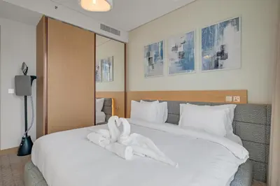 a bedroom with a bed with a white towel on it at Luxury-Brand New-Direct Access toThe Dubai Mall in Dubai
