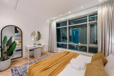 a bedroom with a bed and a large window at The Lofts Downtown - Stunning Burj Khalifa View in Dubai