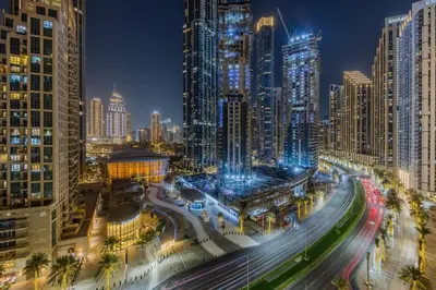 a city at night with traffic and tall buildings at The Lofts Downtown - Stunning Burj Khalifa View in Dubai