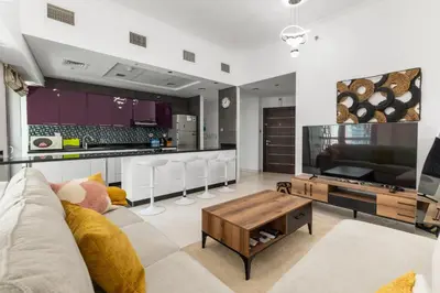 a living room with a couch and a table at 2BR In The World-Famous Twisted Skyscraper in Dubai
