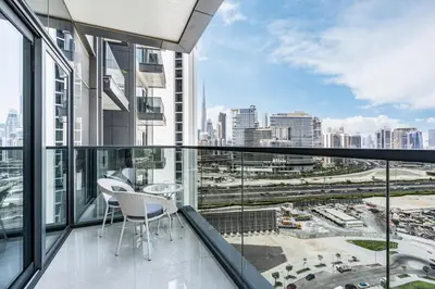 a balcony with two chairs and a view of the city at Premium Central Home with Burj Khalifa View in Dubai