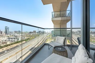 an apartment balcony with a view of a highway at Close to Dubai Miracle Garden, Dubai Autodrome, and Sports City, with JVT Community Park just steps away - The Ivy, Jumeirah Village Triangle by Deluxe Holiday Homes in Dubai