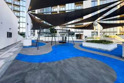 a large building with blue paint on the floor at High-Floor 2BR with Skyline Views, Steps from a Park, Minutes Drive to Meydan Golf Club and Ras Al Khor Wildlife Sanctuary, Sobha Hartland The Crest Tower C, Sobha Hartland by Deluxe Holiday Homes in Dubai