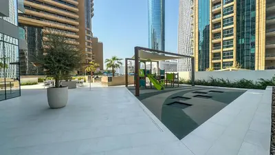 a playground in a city with tall buildings at Luxury Stay 1BR, Waterfront in Marina LIV Tower - 20AB05 in Dubai