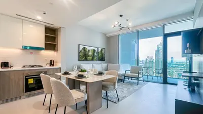 a kitchen and dining room with a table and chairs at Luxury Stay 1BR, Waterfront in Marina LIV Tower - 20AB05 in Dubai