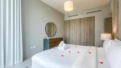 a bedroom with a white bed and a mirror at Luxury Stay 1BR, Waterfront in Marina LIV Tower - 20AB05 in Dubai