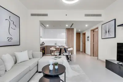 a living room with a white couch and a table at Exclusive Marina Lifestyle with Stunning Views in Dubai