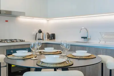 a table with plates and glasses on it in a kitchen at Exclusive Marina Lifestyle with Stunning Views in Dubai