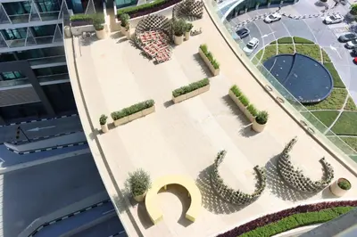 an overhead view of a courtyard with cactus at Beachfront 1BR Seven Palm Rooftop Pool & Views in Dubai