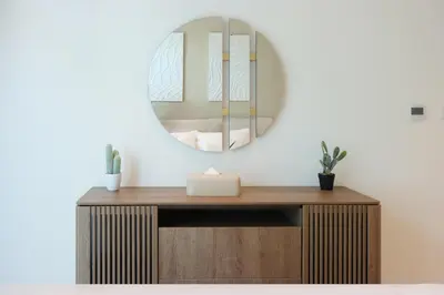 a bathroom with a mirror on a wooden vanity at Beachfront 1BR Seven Palm Rooftop Pool & Views in Dubai