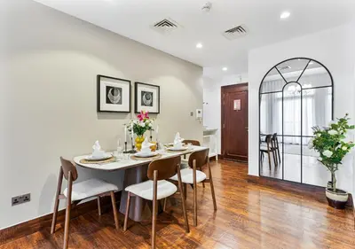 a dining room with a table and chairs at 2BR Downtown Dubai 5 Min Walk to Dubai Mall & Burj in Dubai
