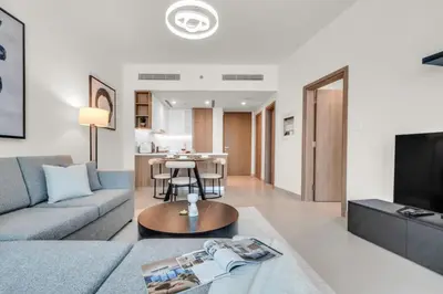 a living room with a couch and a table at Modern Waterfront Living with Stunning Views in Dubai