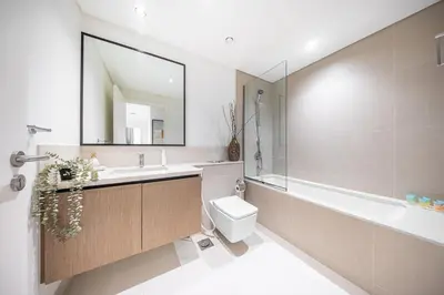 a bathroom with a sink and a toilet and a tub at DVH Luxe Retreats 2 Bedroom Downtown by Burj Khalifa and Dubai Mall in Dubai