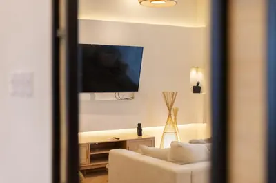 a living room with a couch and a flat screen tv at Luxury 5 Star Newly Furnished 3BR Apartment in Dubai Marina in Dubai