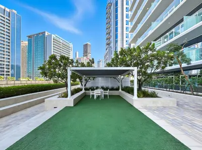 a gazebo with two chairs and a green lawn at New 1BR with Burj Khalifa Views Near Dubai Mall in Dubai