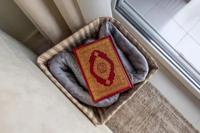 a book sitting in a basket next to a window at New 1BR with Burj Khalifa Views Near Dubai Mall in Dubai