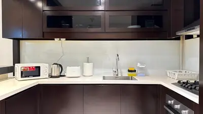 a kitchen with a sink and a microwave at LUX 1BR 5 Min Walk Dubai Mall - DAMAC Upper Crest in Dubai