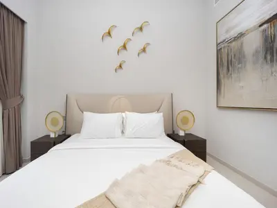 a bedroom with a bed with birds on the wall at Grande Signature 2BR Burj Khalifa & Dubai Fountain in Dubai