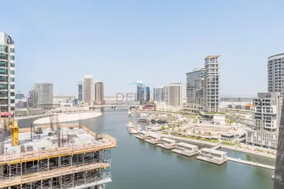 a river in a city with boats in the water at Stunning 1BR with Panoramic Canal Views, Convenient Downtown Access and Walking Distance to Bus Stop, J One - 1, Business Bay by Deluxe Holiday Homes in Dubai
