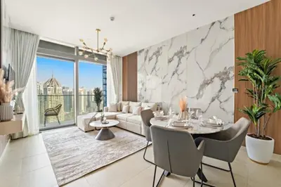 a living room with a couch and a table with chairs at FIRST CLASS 1BR Breathtaking Marina Views in Dubai