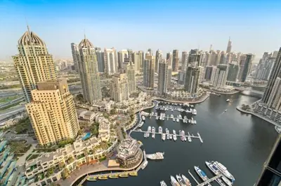 an aerial view of a city with a harbor with boats at FIRST CLASS 1BR Breathtaking Marina Views in Dubai