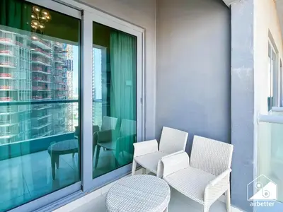 a balcony with two chairs and a table at Luxury 2-Bedroom Apartment, Downtown Skyline Views in Dubai