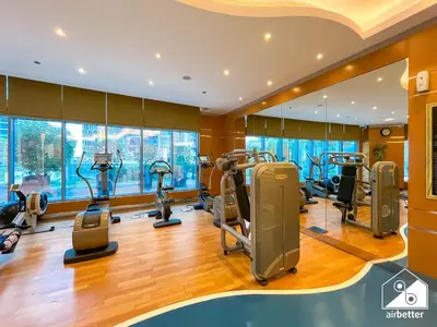 a gym with treadmills and elliptical machines at Luxury 2-Bedroom Apartment, Downtown Skyline Views in Dubai
