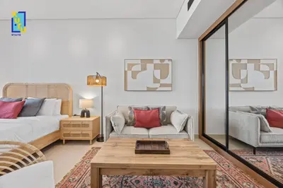 a living room with a bed and a coffee table at Timeless & Textured Studio w Jacuzzi Trillionaire in Dubai