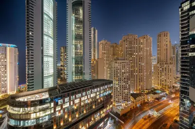a city skyline at night with tall buildings at FIRST CLASS 1BR Marina Skyline Escape in Dubai