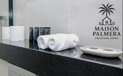 a bathroom counter with a pile of towels on it at Park Vista-Infinity Pool View in Dubai