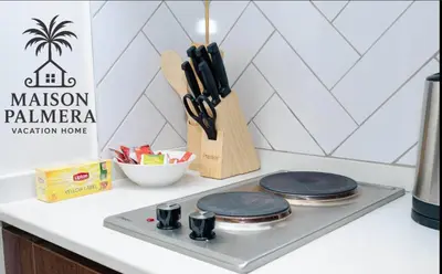 a kitchen counter with three plates on a stove at Park Vista-Infinity Pool View in Dubai