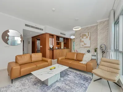 a living room with two couches and a coffee table at Panoramic Burj 5br Condo with Full Led & Fountain View in Dubai