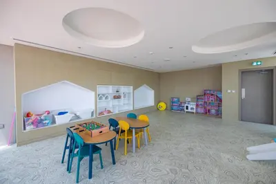 a room with two tables and chairs and a play area at Modern & Luxurious 2BR Penthouse in MBR City District One Dubai in Dubai