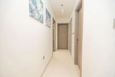 a hallway of a house with white walls and white floors at Modern & Luxurious 2BR Penthouse in MBR City District One Dubai in Dubai