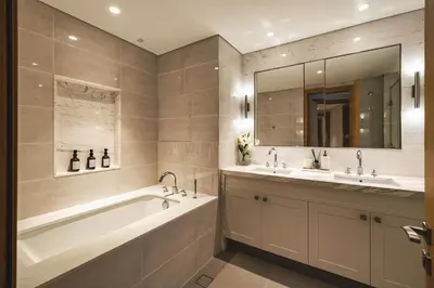 a bathroom with two sinks and a tub and a mirror at The Opera Grand Ultra Luxury Suite Burj Khalifa and Fountain View in Dubai