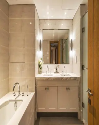 a bathroom with two sinks and a tub and a mirror at The Opera Grand Ultra Luxury Suite Burj Khalifa and Fountain View in Dubai