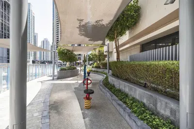 a red and yellow fire hydrant in front of a building at The Opera Grand Ultra Luxury Suite Burj Khalifa and Fountain View in Dubai