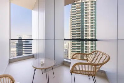 a room with two chairs and a table and some windows at Marina 2BR 58th Floor Sea and City Views Pool Gym in Dubai