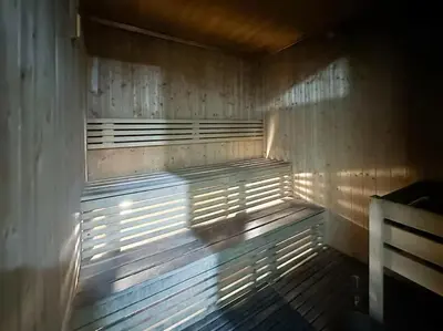 a wooden bench in a room with the sun shining on it at Marina 2BR 58th Floor Sea and City Views Pool Gym in Dubai